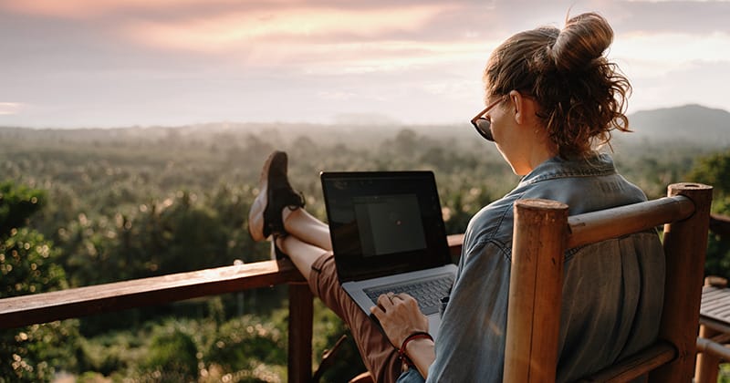 Female Landscaper Researching on Computer in Front of View