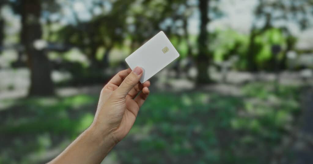 Hand-holding-up-landscaping-business-credit-card-with-trees-in-background (1)