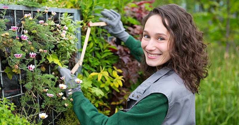 Happy Female Landscaper Working and Smiling at Camera