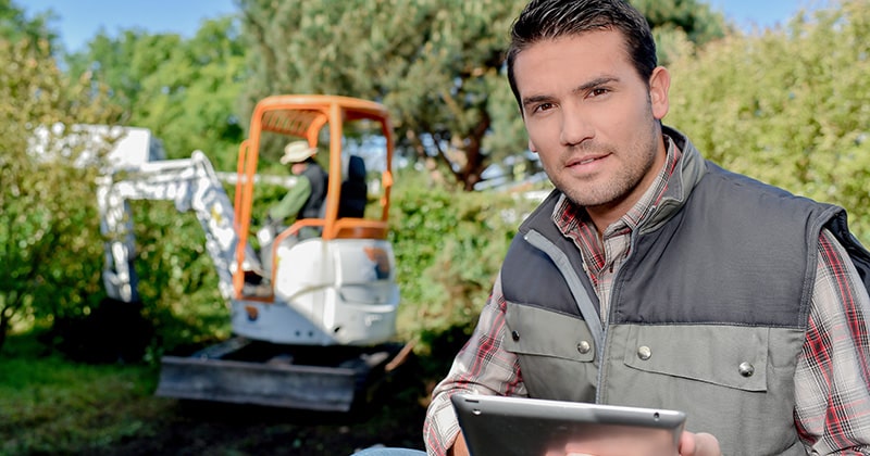 Landscaper on the Job Looking at Tablet