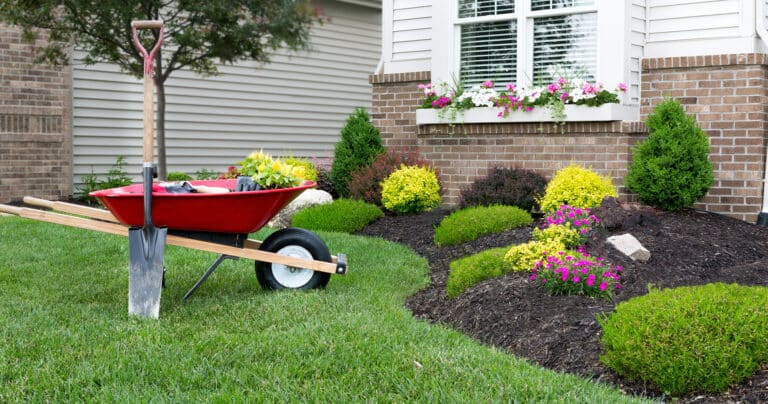 Red Wheelbarrow in Front of House