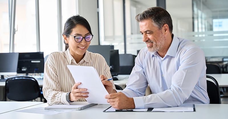 Young woman having middle aged man sign landscaping contract