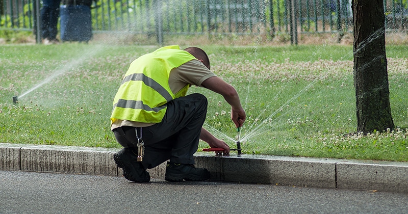 landscape-employee-fixing-sprinklers